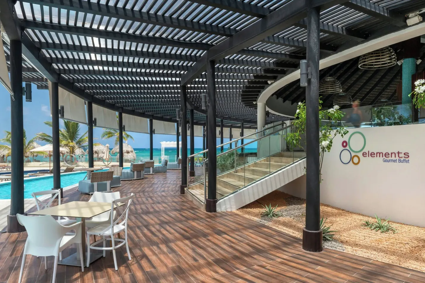 Elements terrace entrance with pool and beach views at Royalton CHIC Punta Cana Resort & Casino.