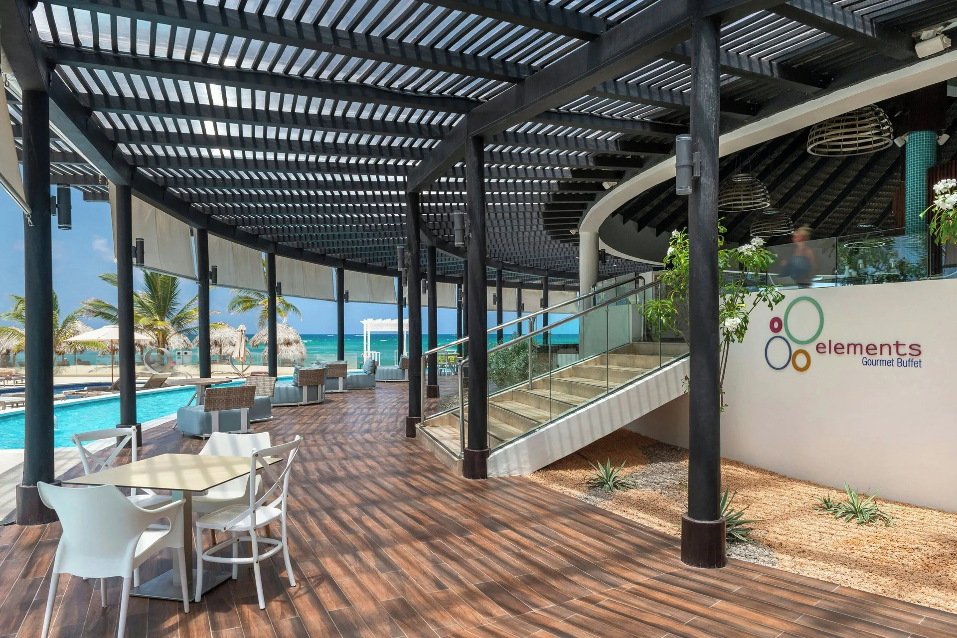 Elements terrace entrance with pool and beach views at Royalton CHIC Punta Cana Resort & Casino.