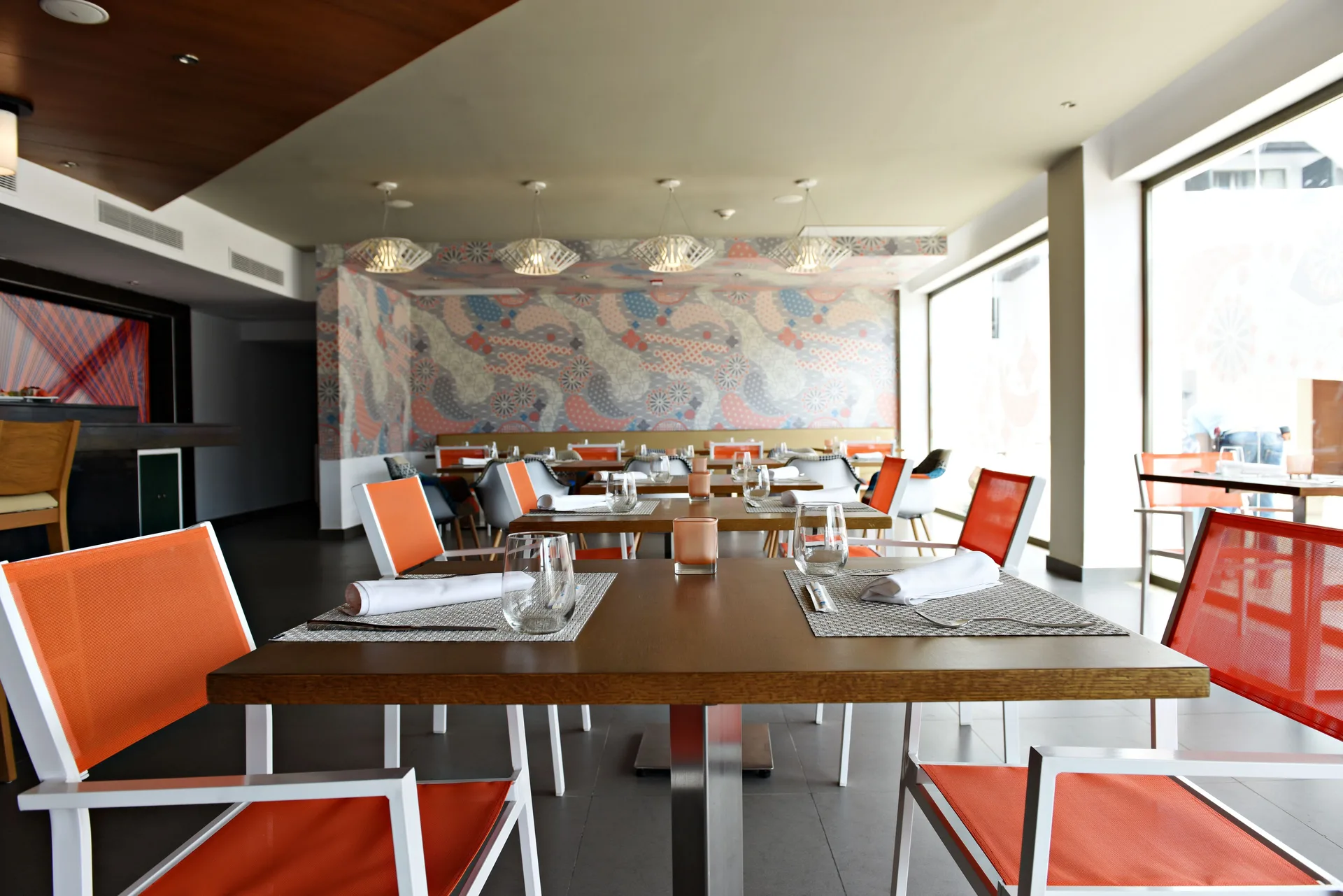 Modern dining room with orange chairs at Royalton CHIC Punta Cana Resort & Casino.