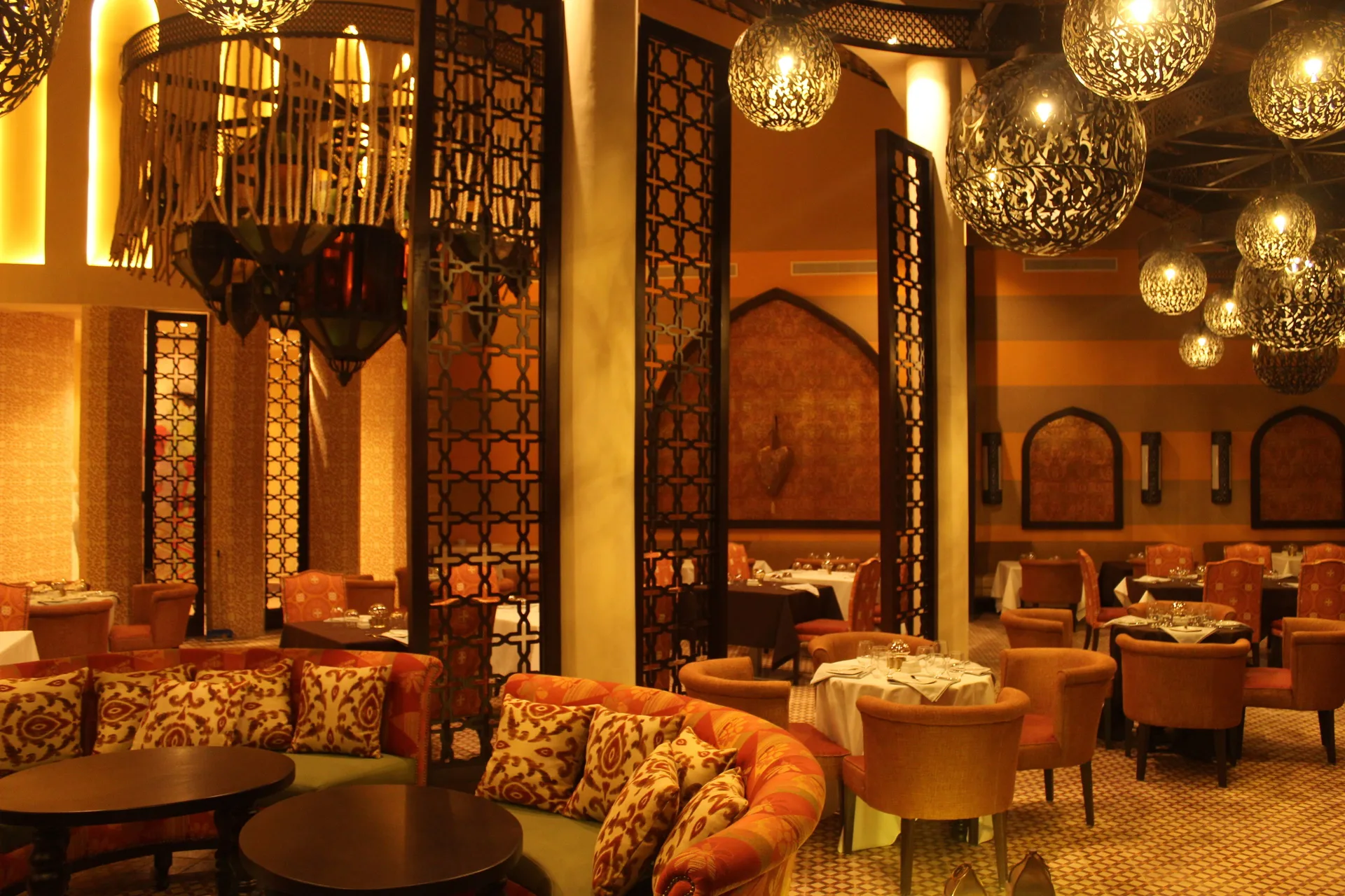 Warmly lit restaurant dining room at Royalton CHIC Punta Cana Resort & Casino.
