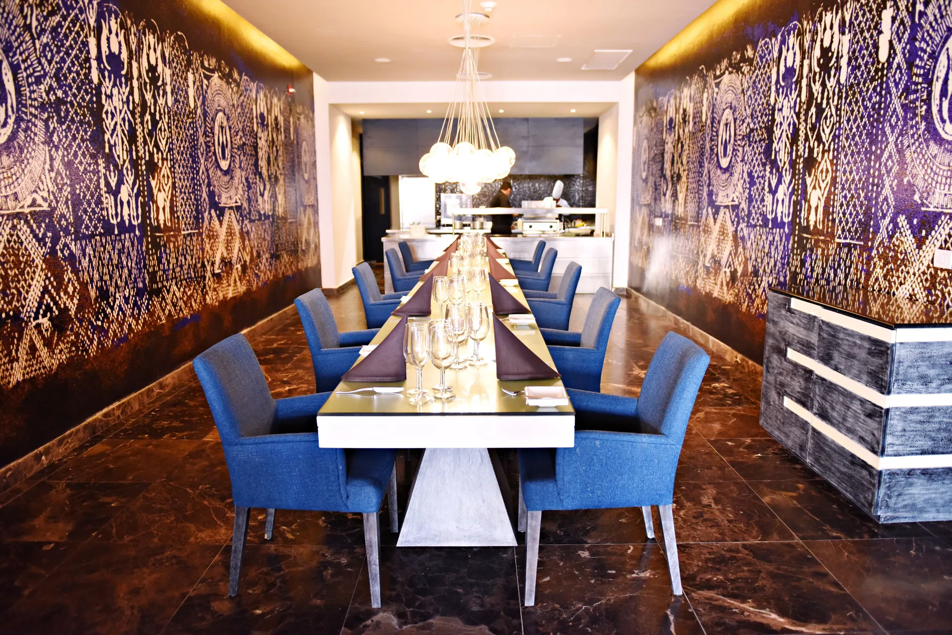 Long tasting table in a patterned dining room at Royalton CHIC Punta Cana Resort & Casino.