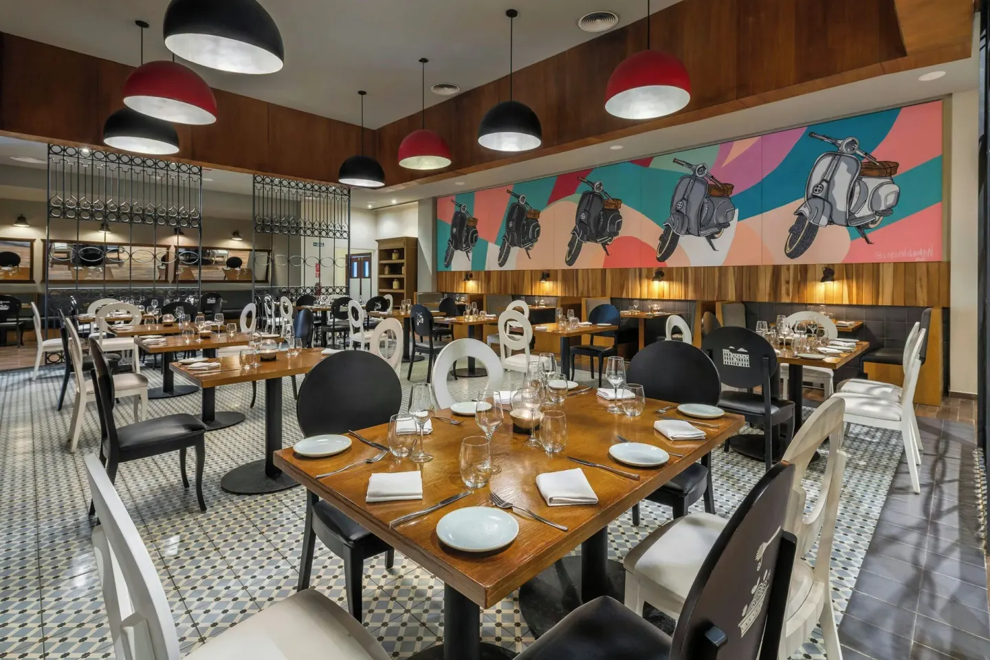 Italian-themed dining room with scooter mural at Royalton CHIC Punta Cana Resort & Casino.
