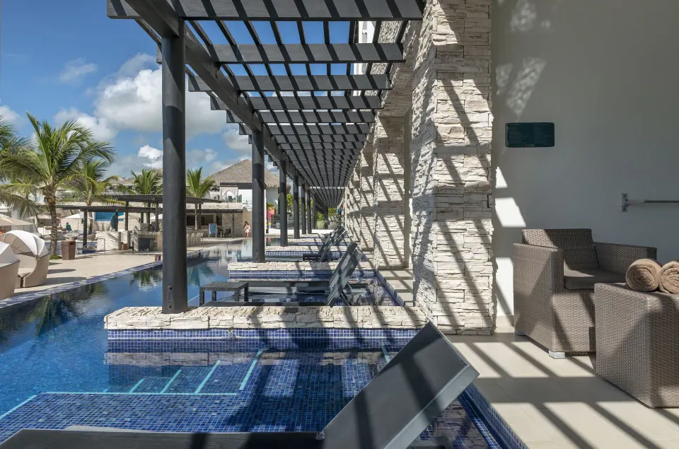Poolside swim-out patio with loungers at Royalton CHIC Punta Cana Resort & Casino.