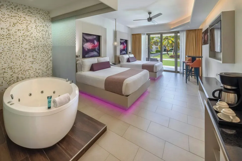 Luxury Junior Suite with soaking tub and two double beds at Royalton CHIC Punta Cana Resort & Casino.