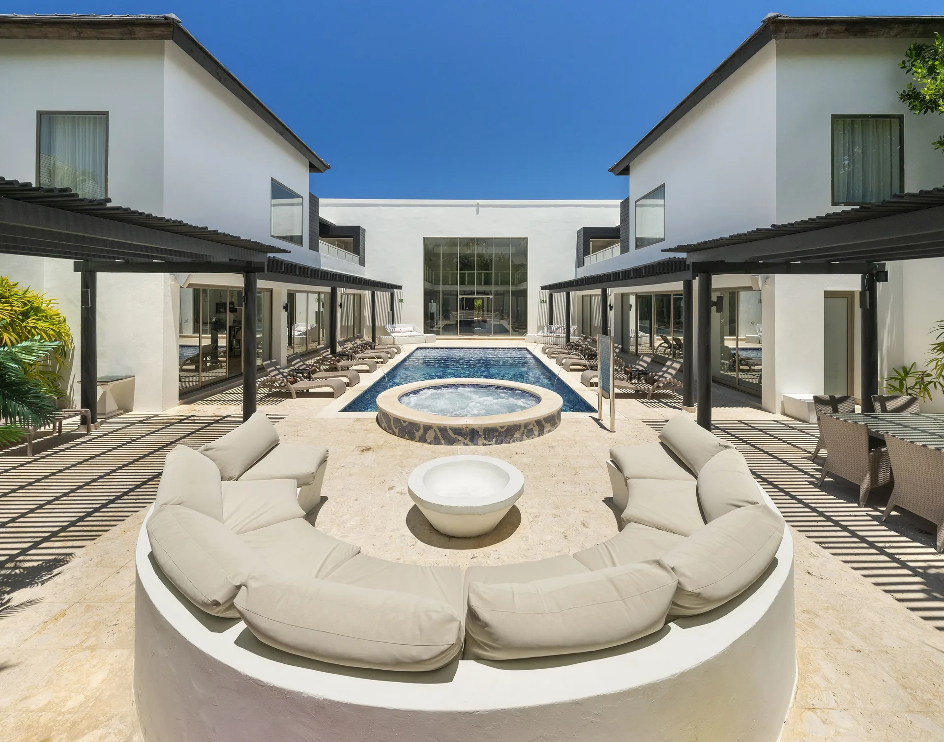 The Mansion courtyard pool and round lounge seating at Royalton CHIC Punta Cana Resort & Casino.