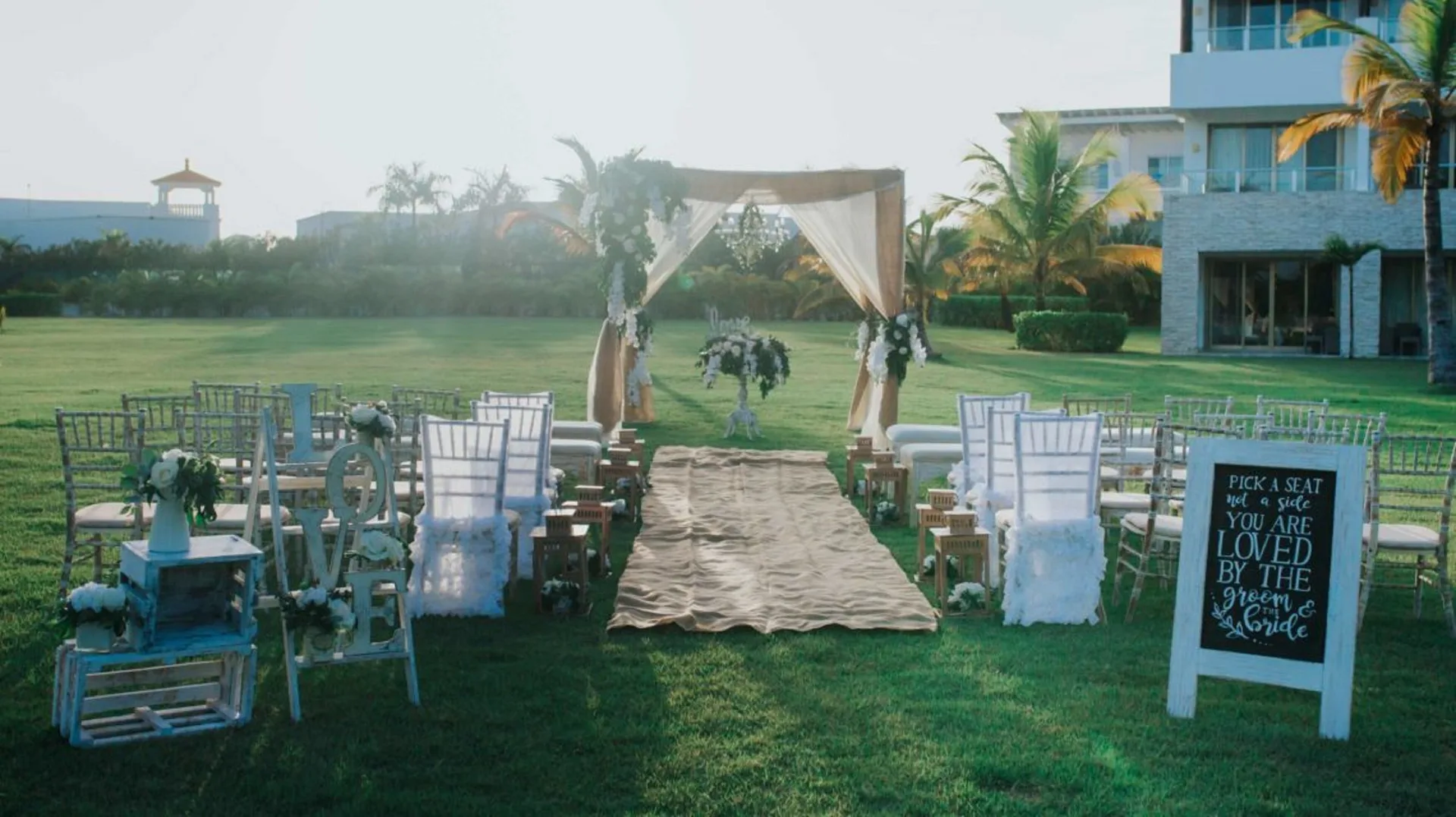 Lawn wedding setup with chairs and arch at Royalton CHIC Punta Cana Resort & Casino.