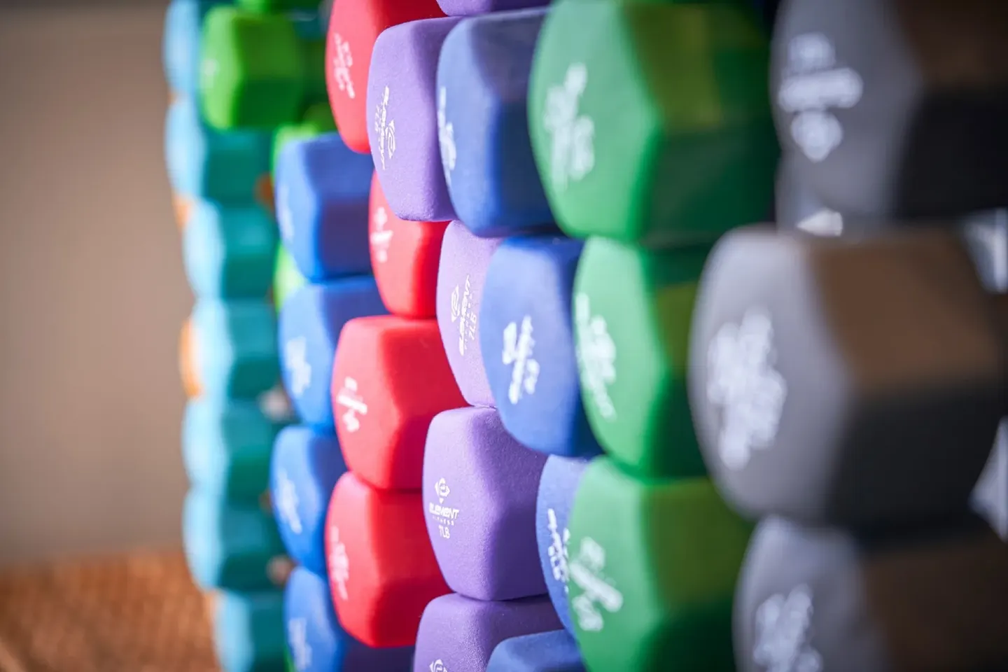 Close-up of colorful dumbbells on a rack at Royalton Grenada.