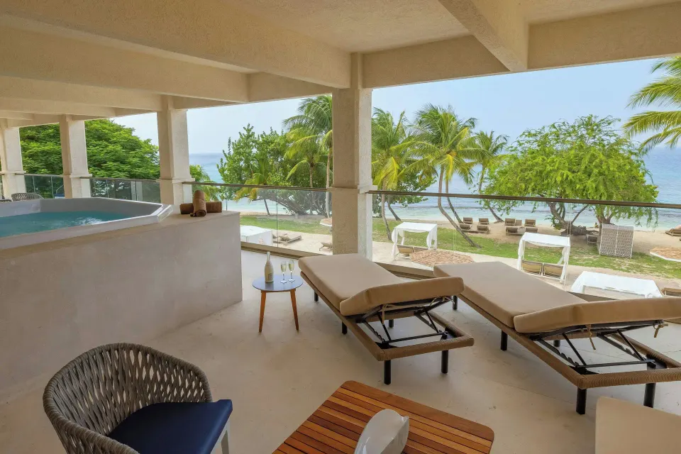 Chairman Two Bedroom Suite terrace with loungers, hot tub and ocean view at Royalton Grenada.