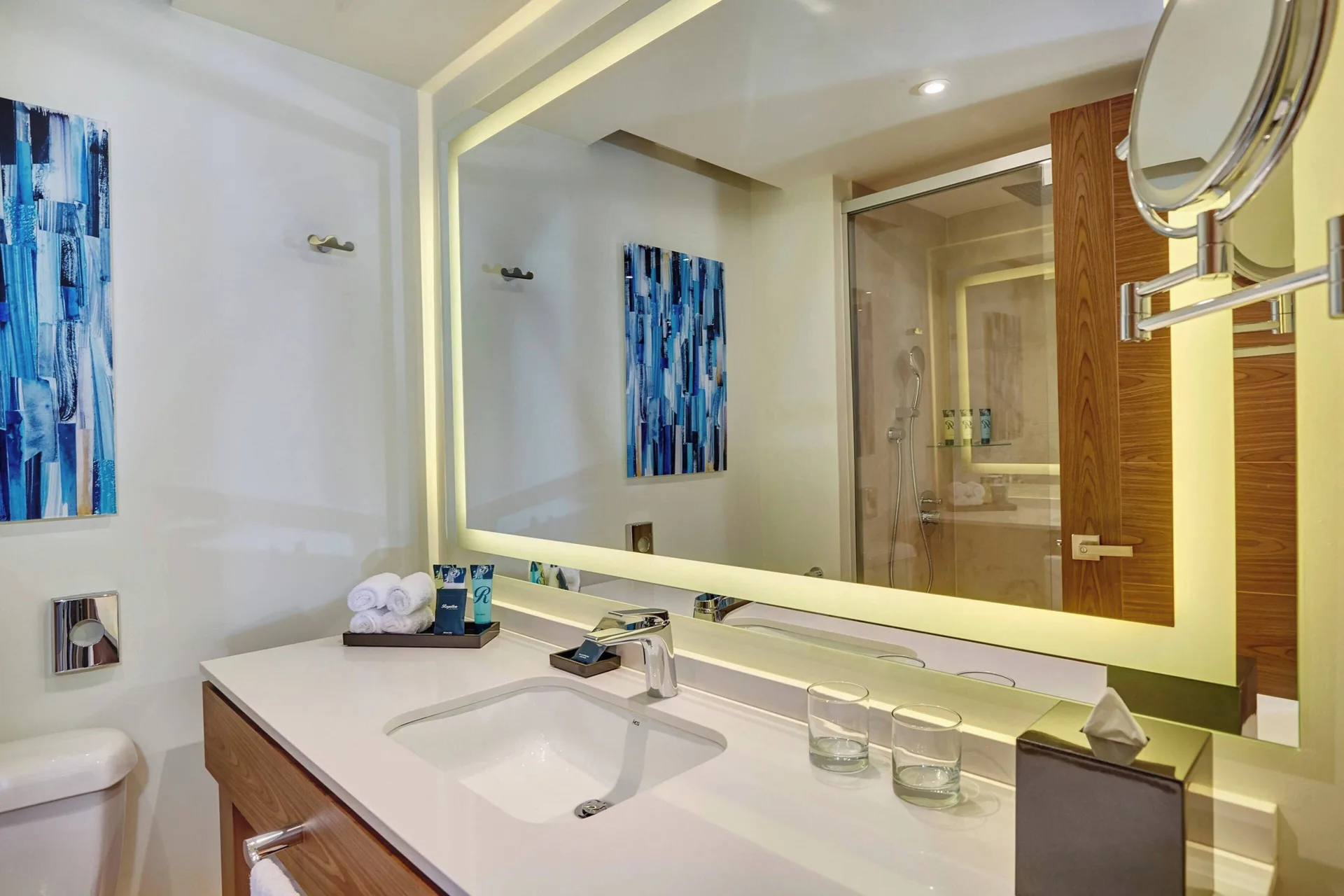Luxury Room bathroom vanity with lit mirror and shower at Royalton Grenada.