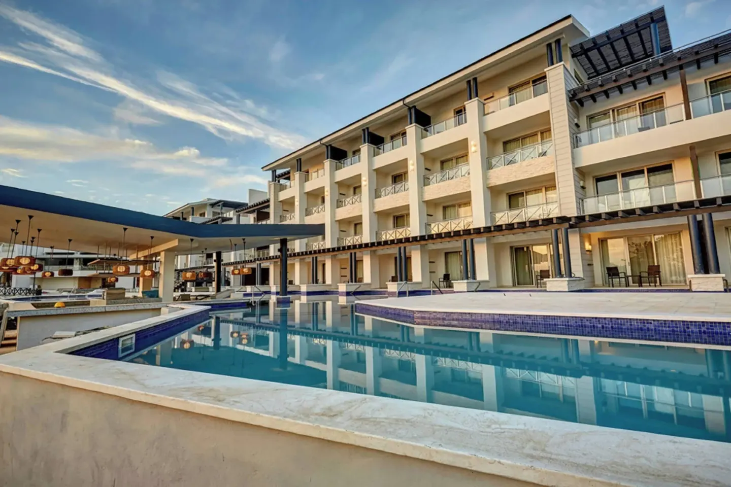 Pool courtyard with balconies and covered bar at Royalton Hideaway Negril.