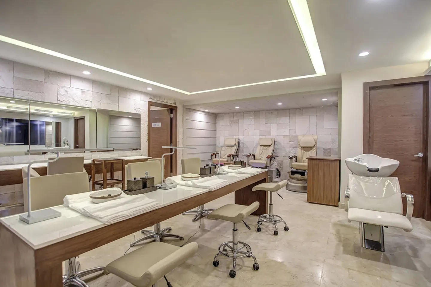 Salon manicure tables, pedicure chairs, and a shampoo station at Royalton Hideaway Negril.