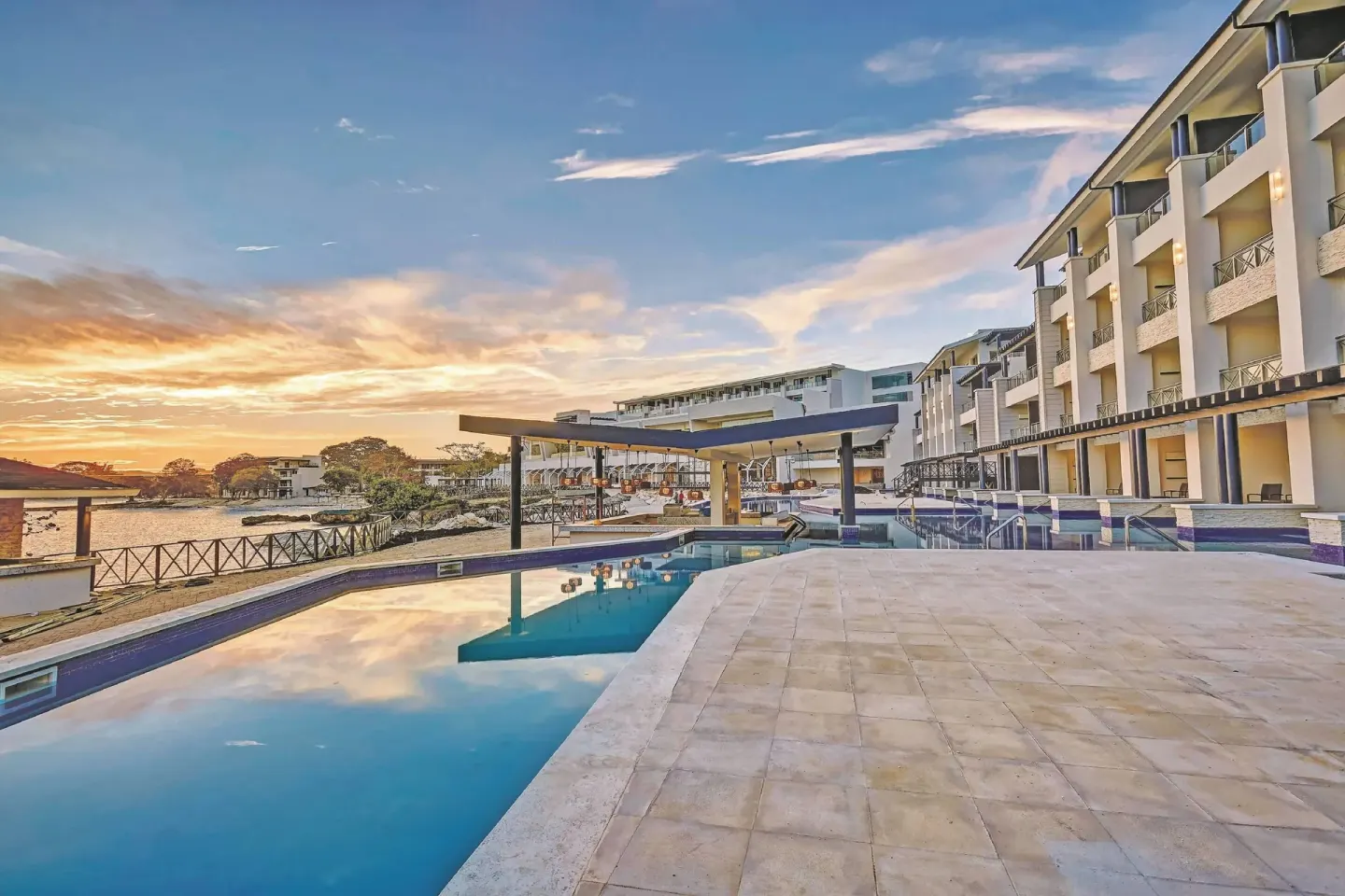 Pool terrace and resort buildings at sunset at Royalton Hideaway Negril.