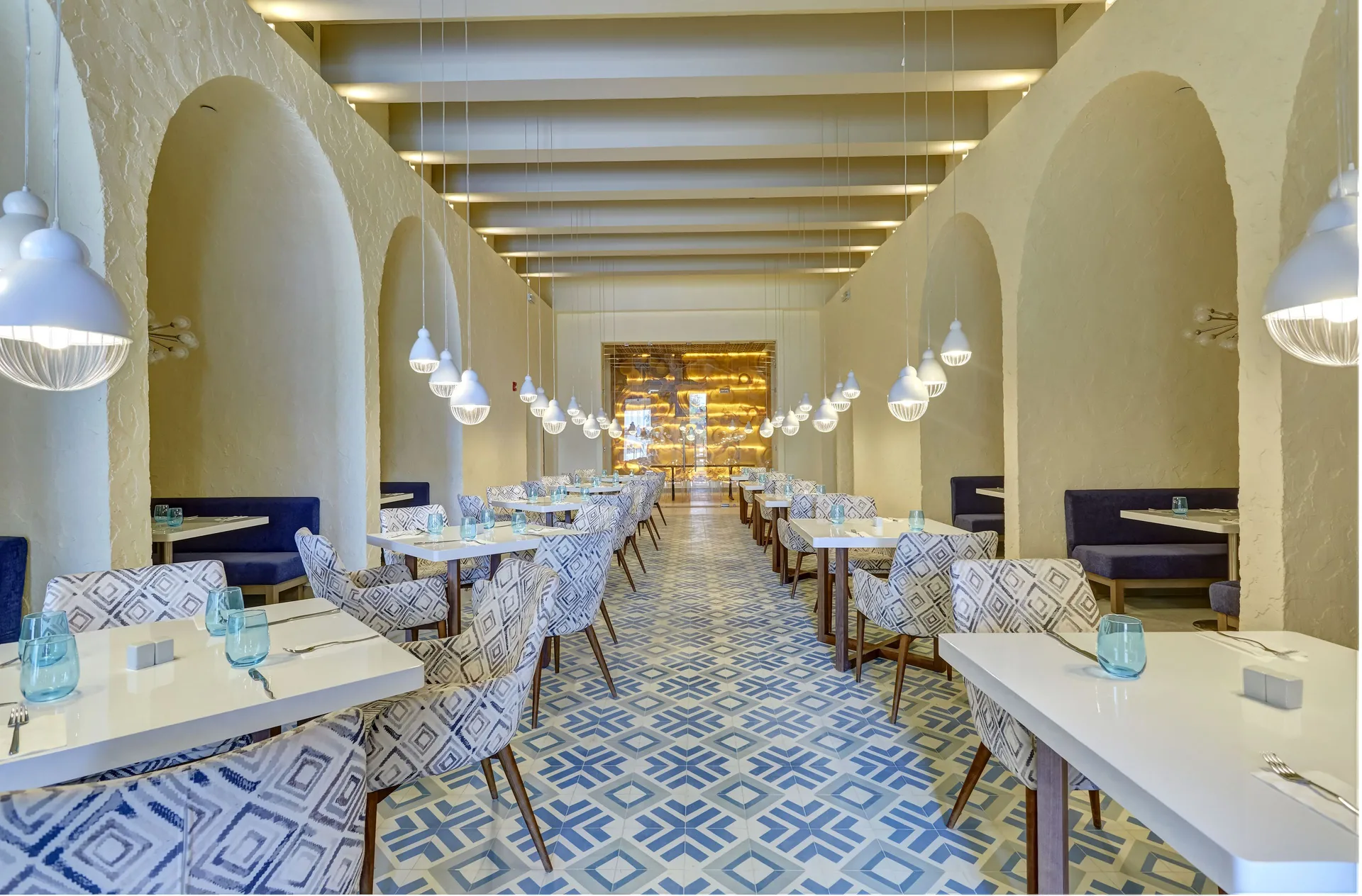 Bright restaurant dining room with arched alcoves at Royalton Hideaway Negril.