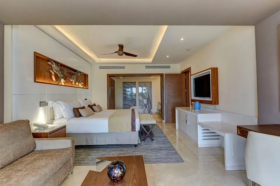 Luxury Junior Suite Ocean View with king bed and lounge seating at Royalton Hideaway Negril.