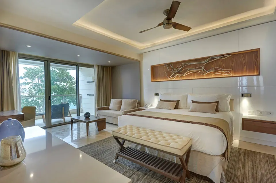 Luxury Junior Suite Ocean View with king bed and sitting area at Royalton Hideaway Negril.