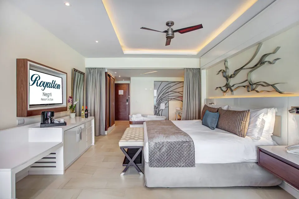 Luxury Junior Suite Ocean View with king bed and vanity area at Royalton Hideaway Negril.