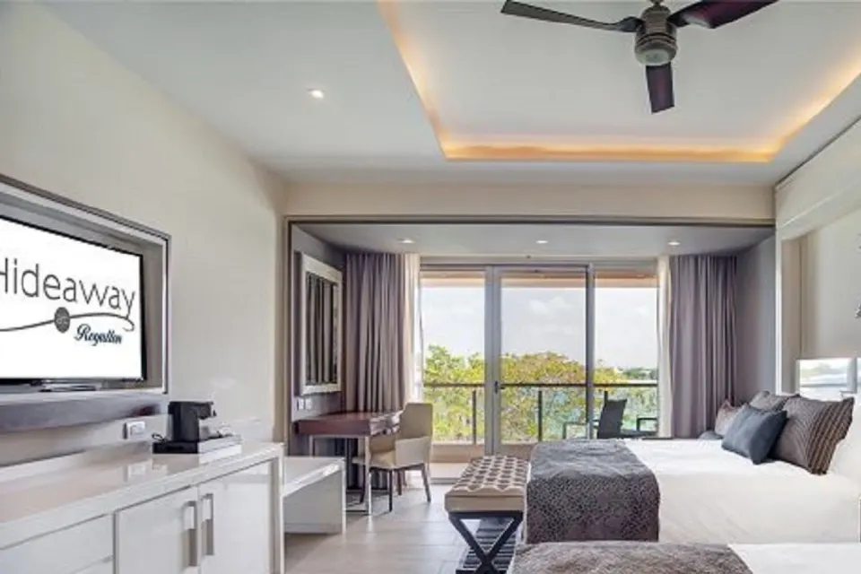 Luxury Junior Suite Ocean View two-bed room with desk and balcony at Royalton Hideaway Negril.