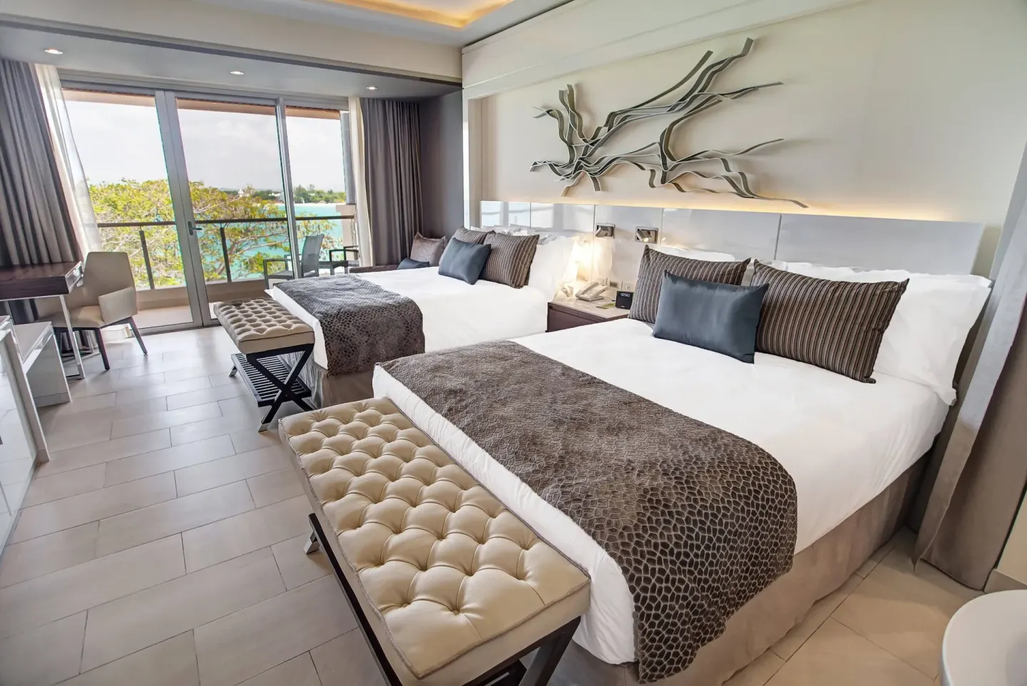 Luxury Junior Suite Ocean View two-bed room with ocean-facing balcony at Royalton Hideaway Negril.