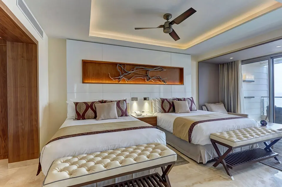 Luxury Junior Suite Ocean View with two beds and benches at Royalton Hideaway Negril.