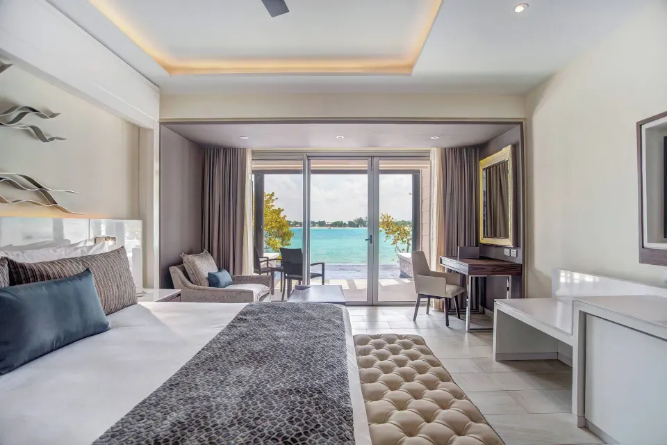 Luxury Junior Suite Swim Out king bed opening to the sea at Royalton Hideaway Negril.