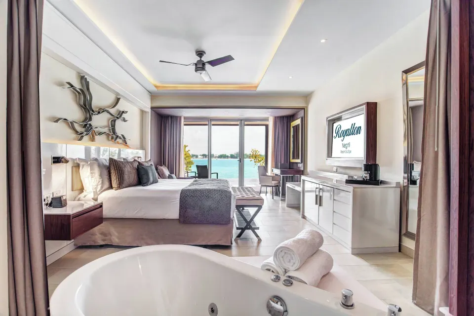 Luxury Junior Suite Swim Out with tub, king bed, and sea view at Royalton Hideaway Negril.