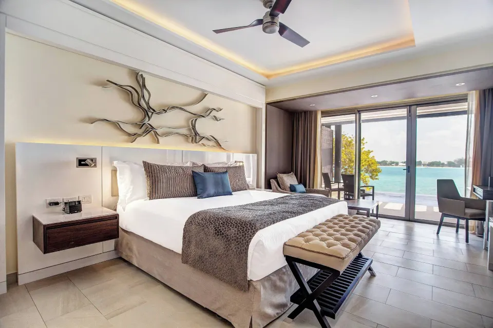 Luxury Junior Suite Swim Out king bed with terrace doors at Royalton Hideaway Negril.