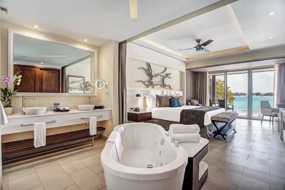 Luxury Junior Suite Swim Out bathroom and king bed at Royalton Hideaway Negril.