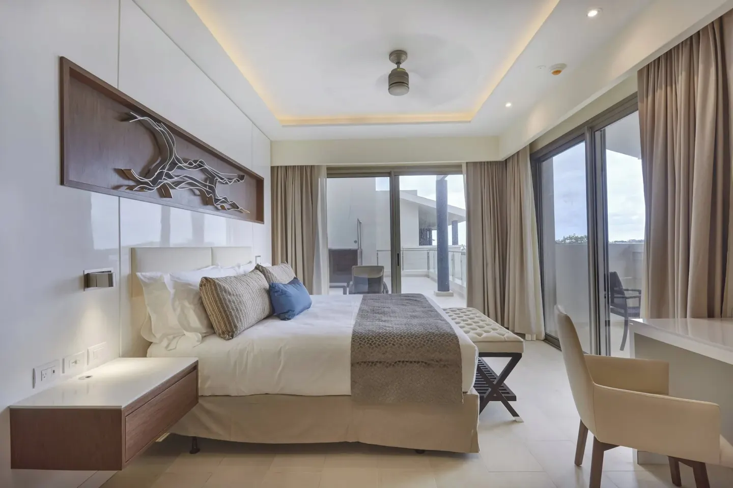 Penthouse king bedroom with balcony doors at Royalton Hideaway Negril.
