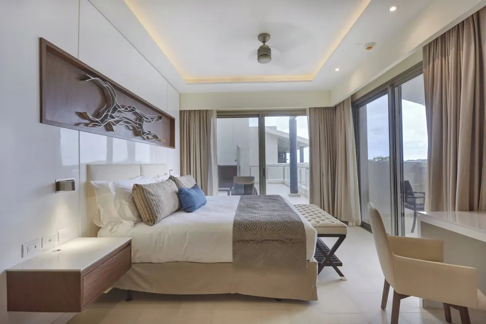 Penthouse king bedroom with balcony doors at Royalton Hideaway Negril.