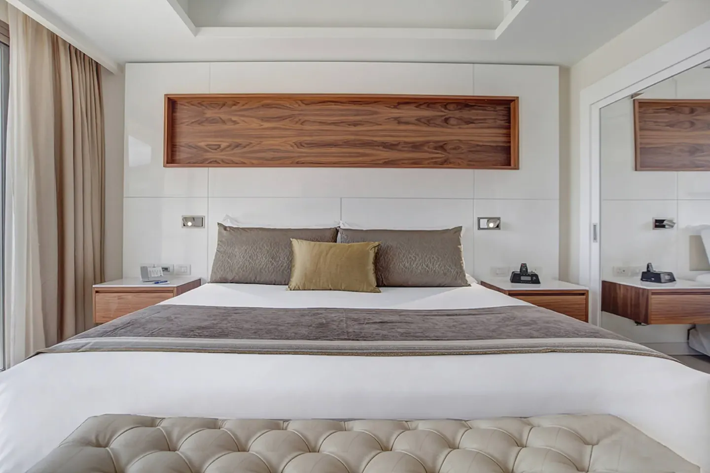 Penthouse king bed with wood headboard panel at Royalton Hideaway Negril.