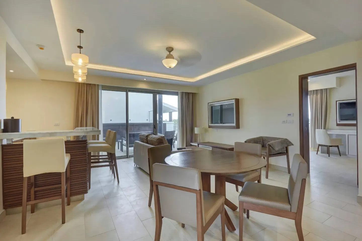 Penthouse suite living and dining area with terrace doors at Royalton Hideaway Negril.