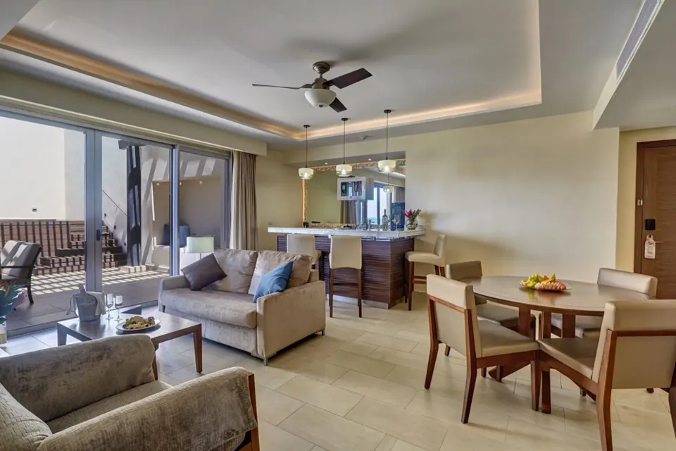 Penthouse suite lounge with sofa, dining table and terrace at Royalton Hideaway Negril.