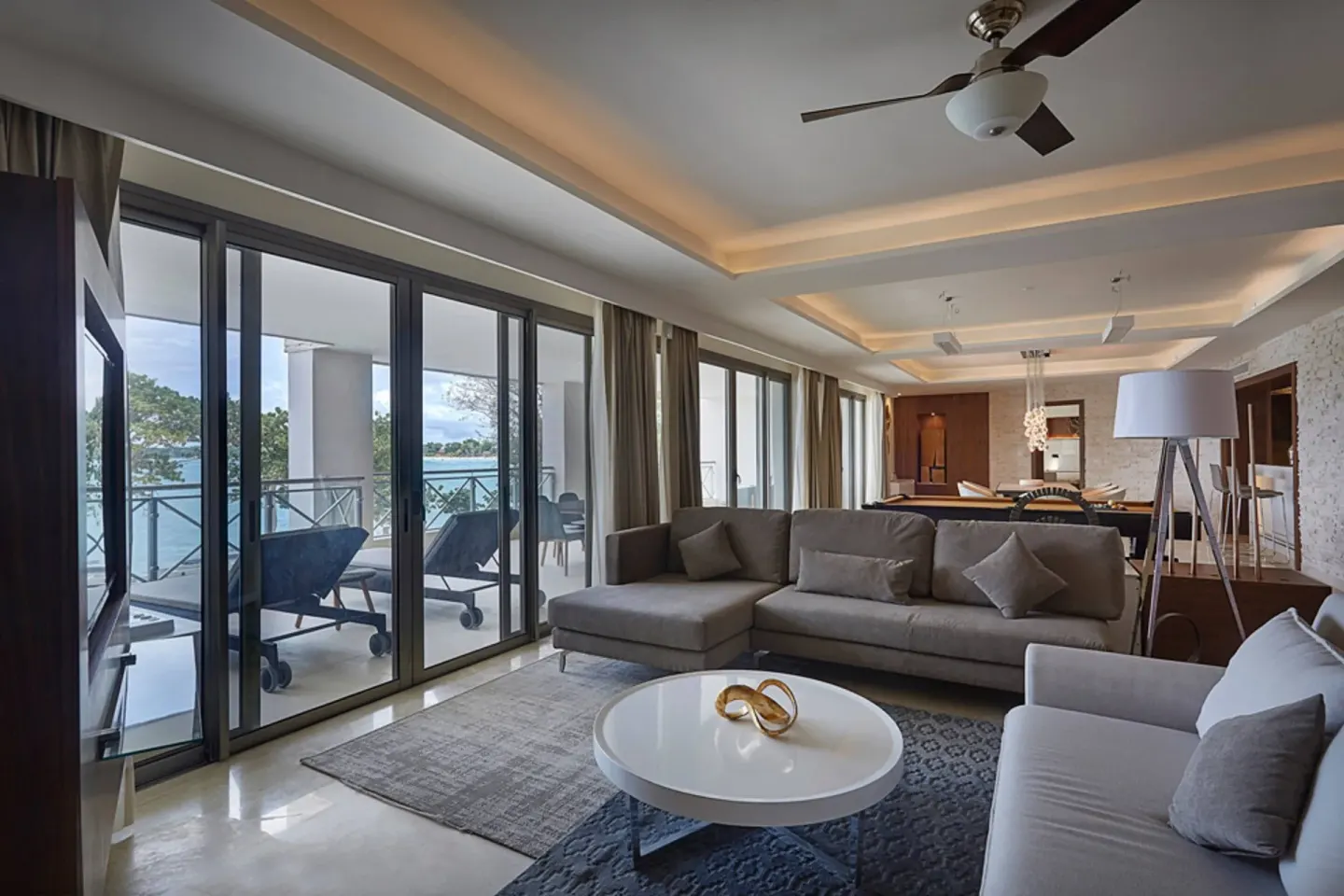 Penthouse living room with sectional sofa and oceanfront terrace at Royalton Hideaway Negril.