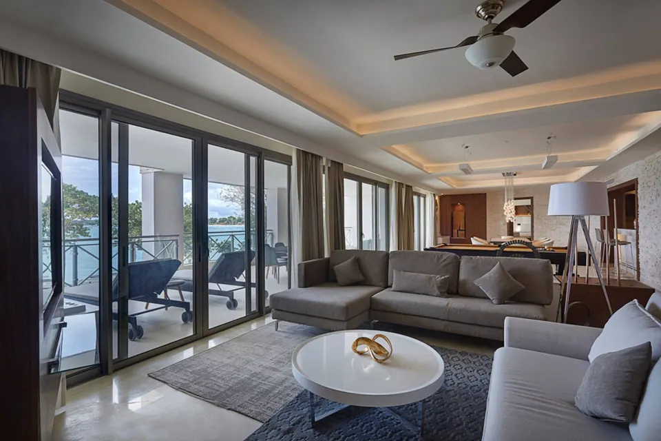 Penthouse living room with sectional sofa and oceanfront terrace at Royalton Hideaway Negril.