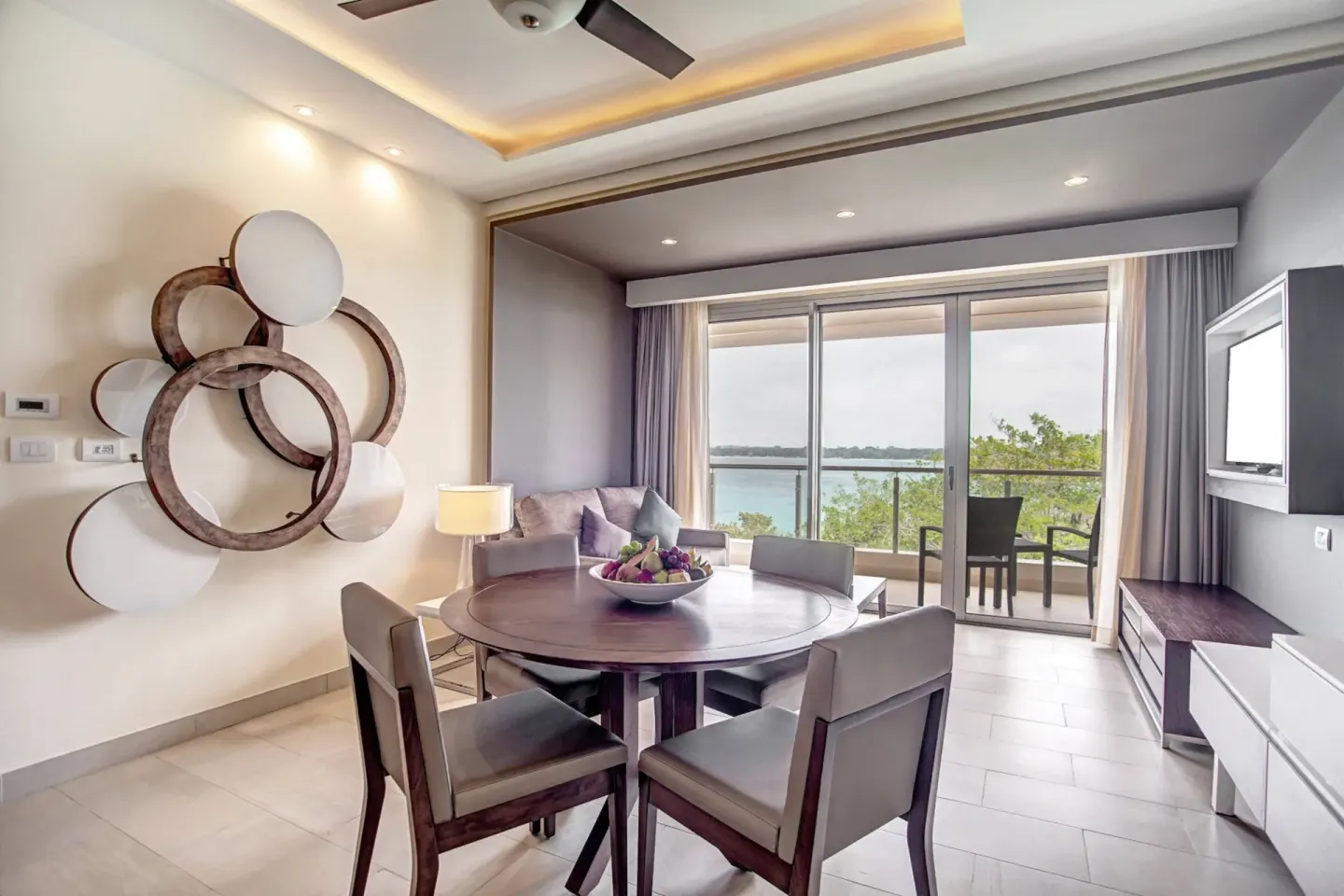 Suite dining and sitting area with balcony ocean view at Royalton Hideaway Negril.