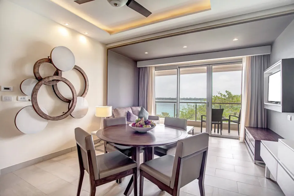 Suite dining and sitting area with balcony ocean view at Royalton Hideaway Negril.