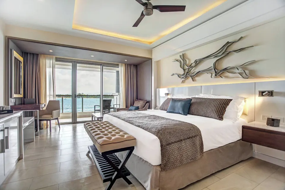 Presidential suite king bed facing an ocean-view balcony at Royalton Hideaway Negril.
