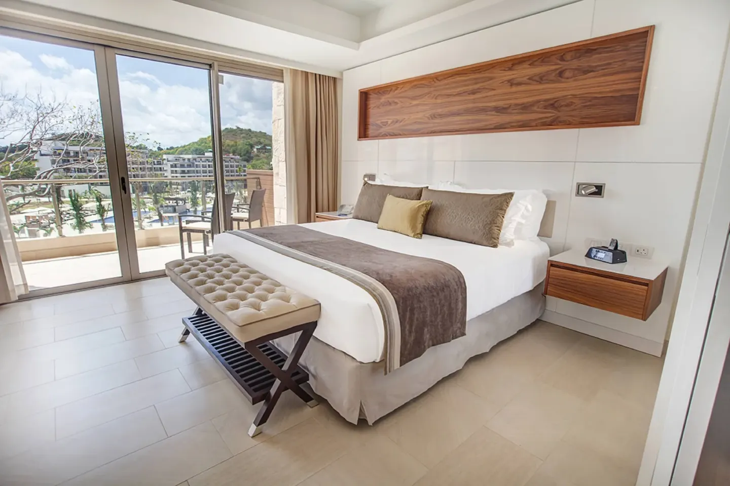 King bedroom with balcony and resort view at Royalton Hideaway Negril.