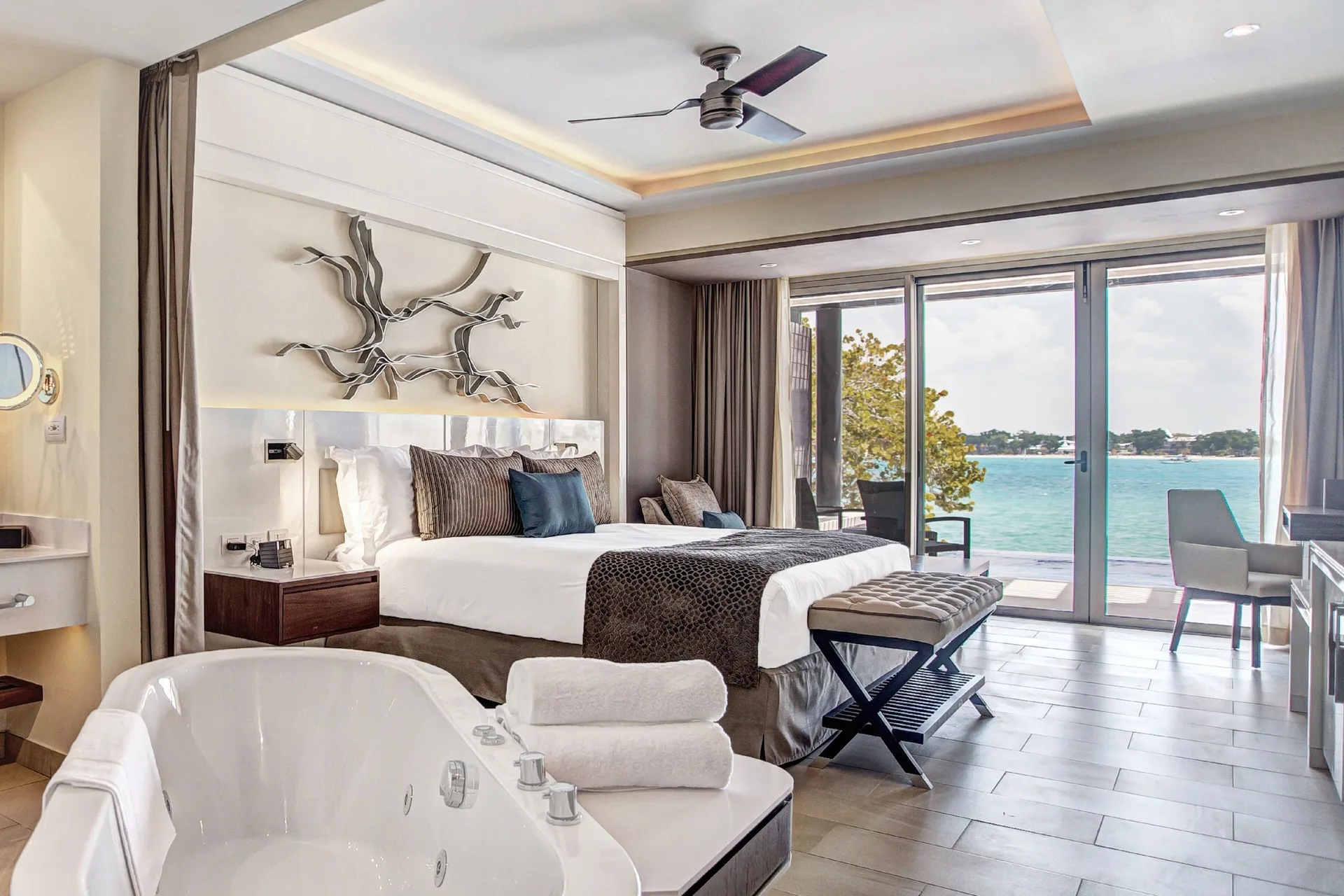 Presidential suite king bed and soaking tub with ocean view at Royalton Hideaway Negril.