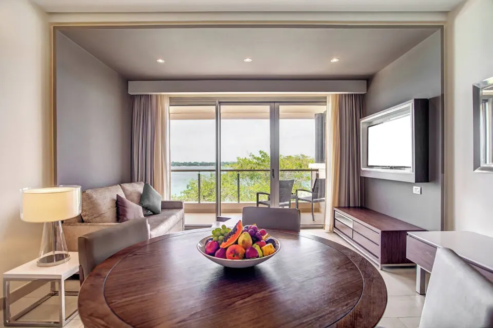Presidential suite living area with dining table and balcony at Royalton Hideaway Negril.