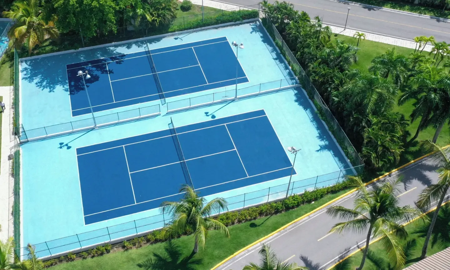 Two blue tennis courts from above at Royalton Hideaway Punta Cana Resort & Casino.