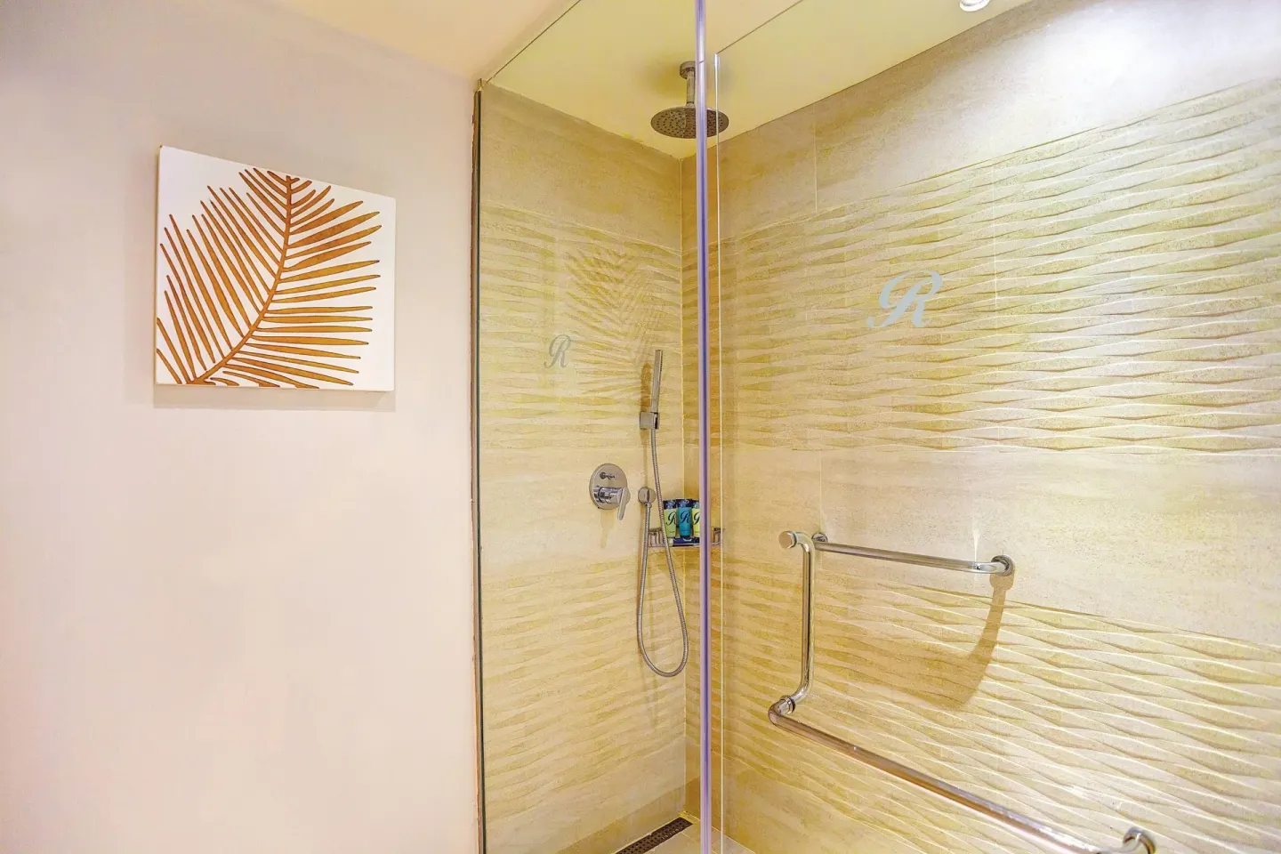 Glass shower with textured tile wall at Royalton Hideaway Punta Cana Resort & Casino.