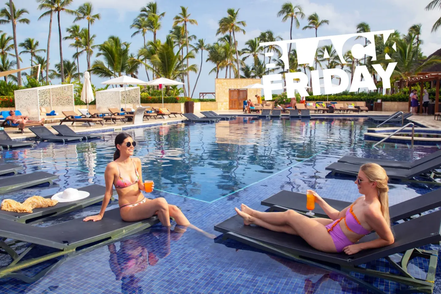 Guests on in-water loungers at a pool at Royalton Hideaway Punta Cana Resort & Casino.