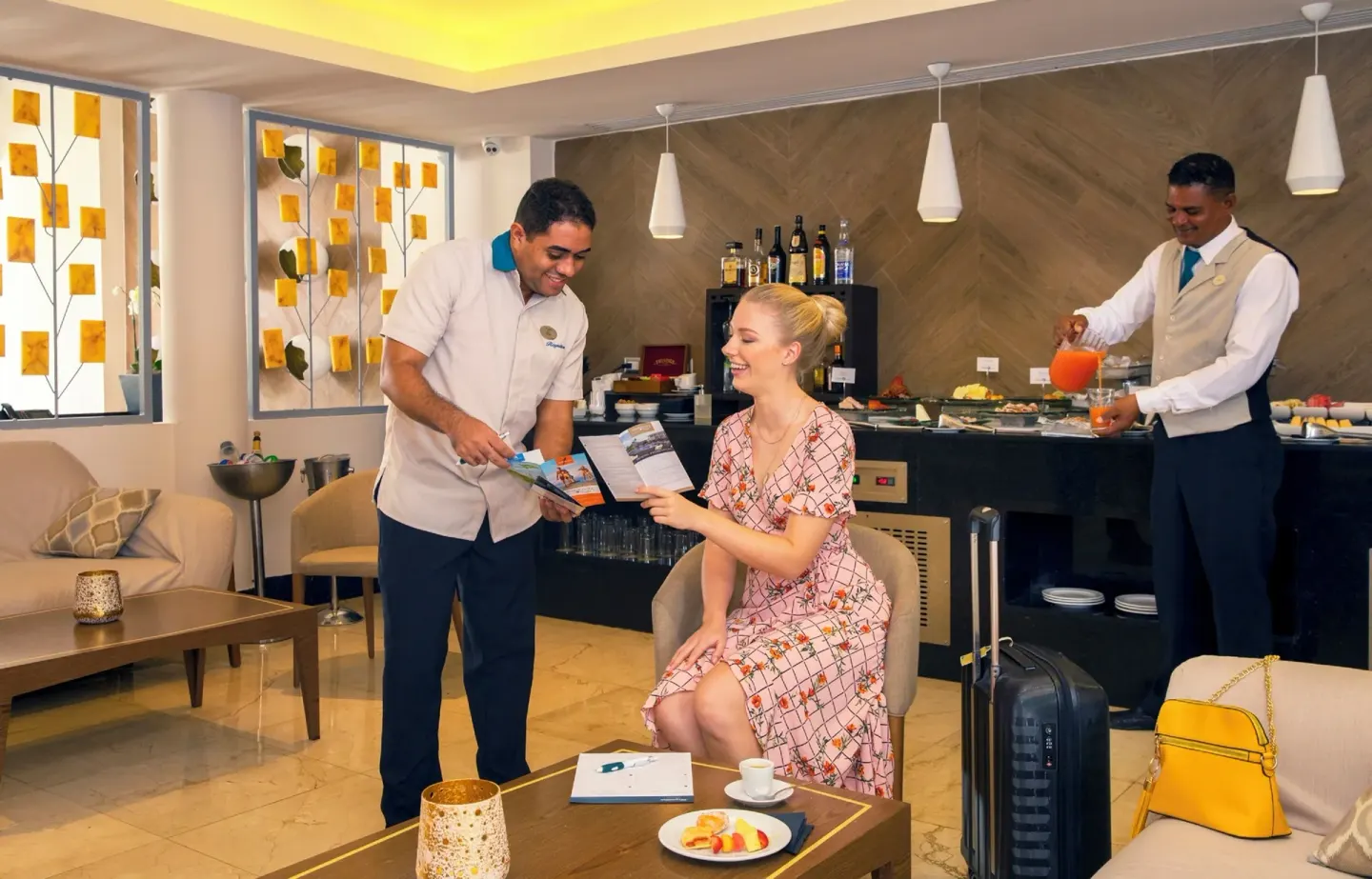 Lounge refreshment area with staff and seated guest at Royalton Hideaway Punta Cana Resort & Casino.