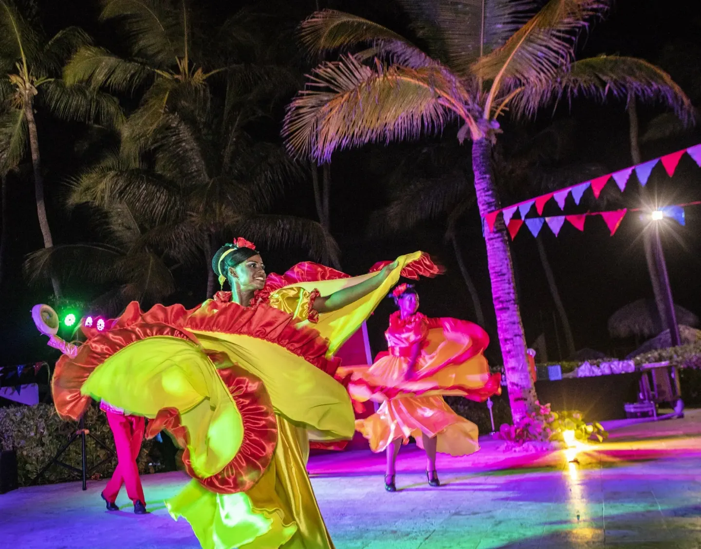 Nighttime dancers in colorful costumes at Royalton Hideaway Punta Cana Resort & Casino.
