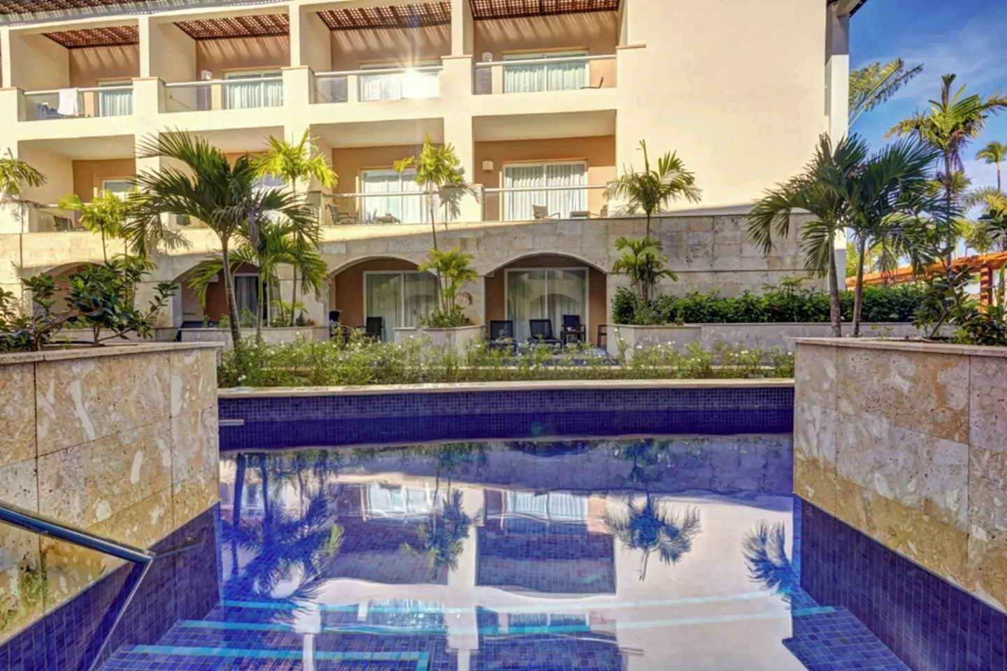 Reflective swim-out pool facing guestroom balconies at Royalton Hideaway Punta Cana Resort & Casino.