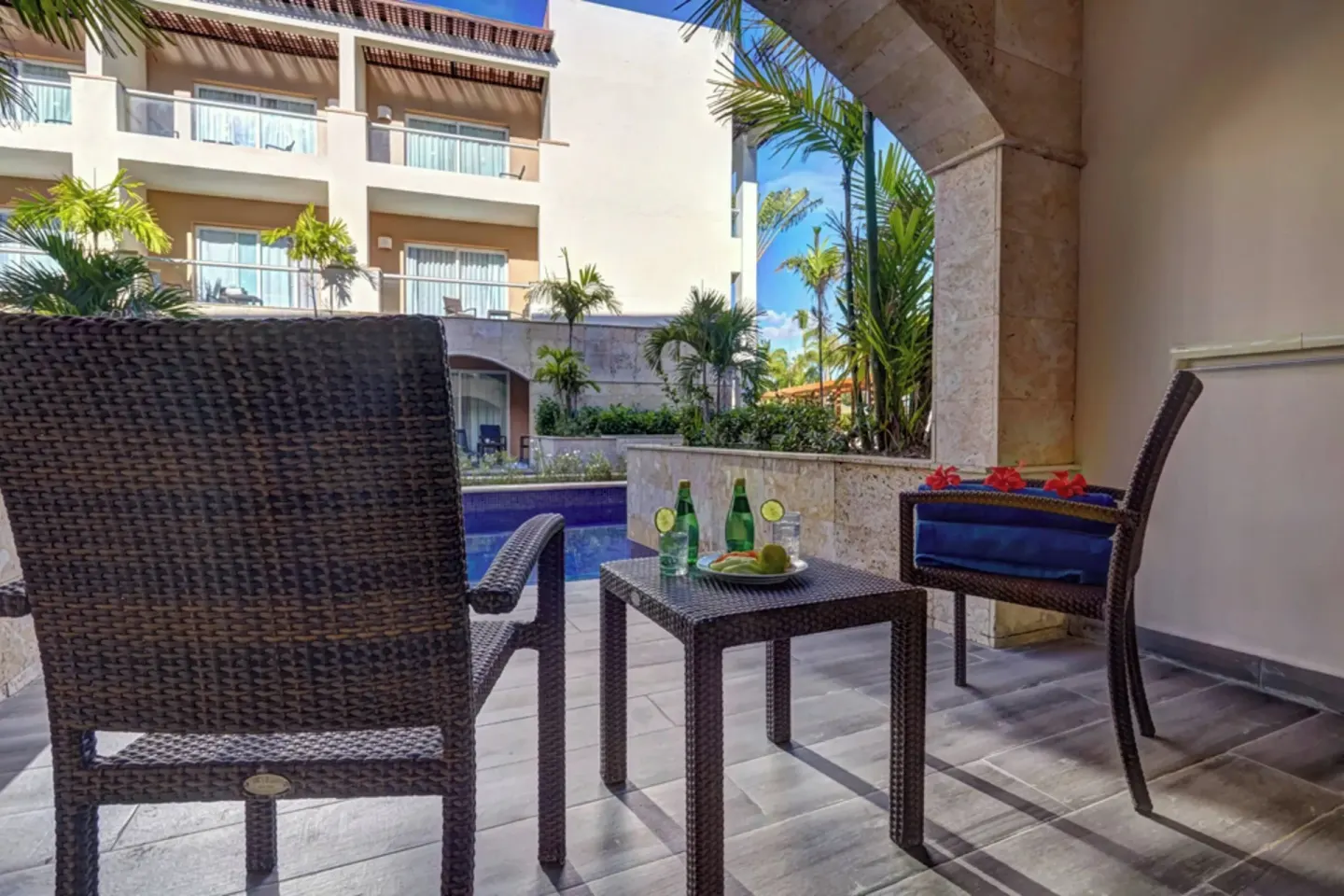 Covered terrace seating beside a swim-out pool at Royalton Hideaway Punta Cana Resort & Casino.