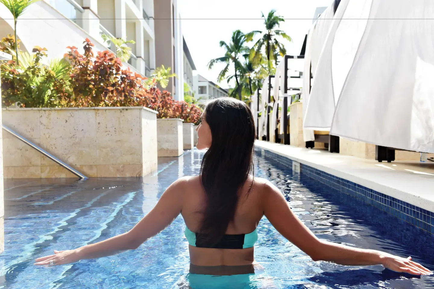 Guest wading in a narrow swim-up pool at Royalton Hideaway Punta Cana Resort & Casino.