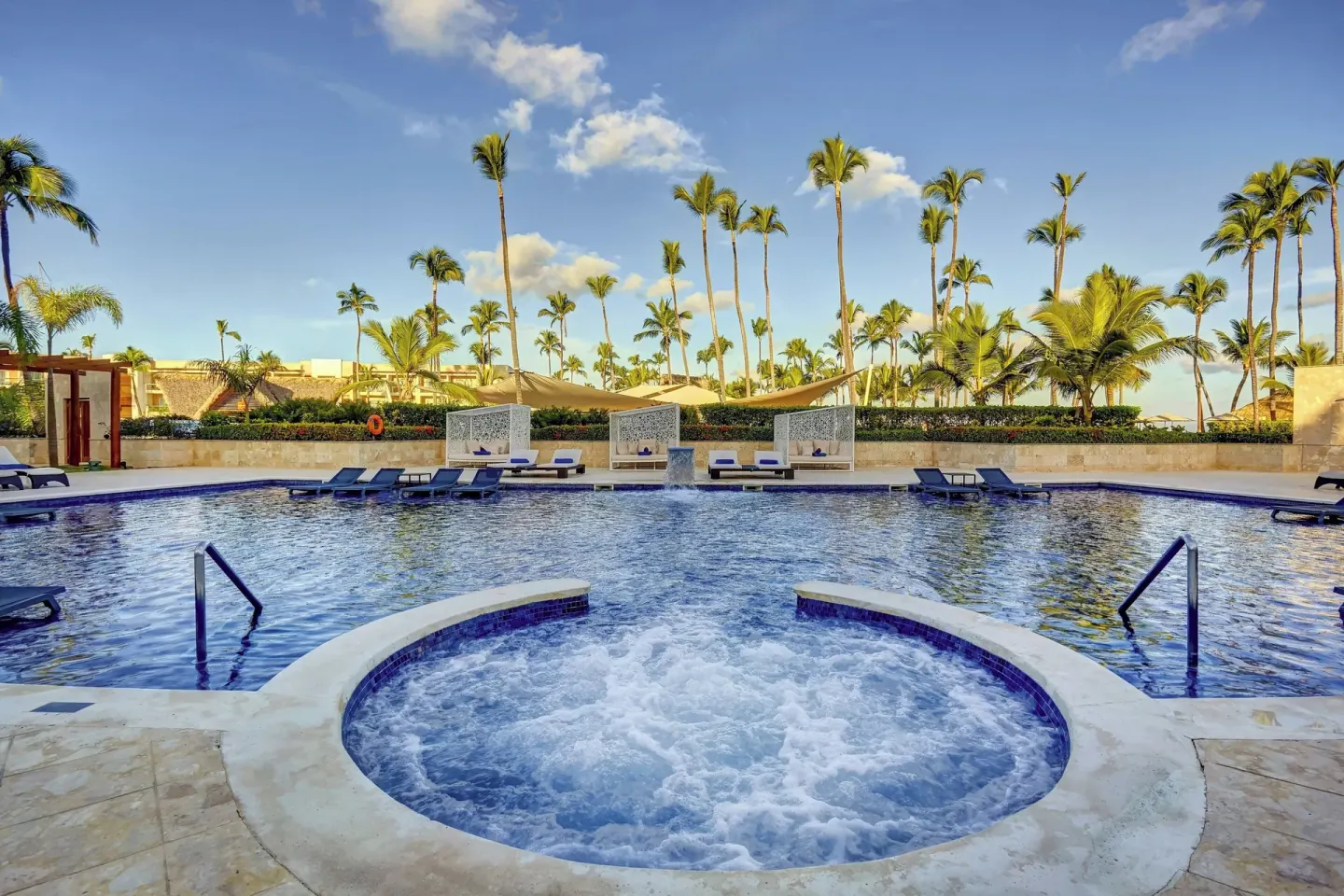Whirlpool and pool with palms at Royalton Hideaway Punta Cana Resort & Casino.