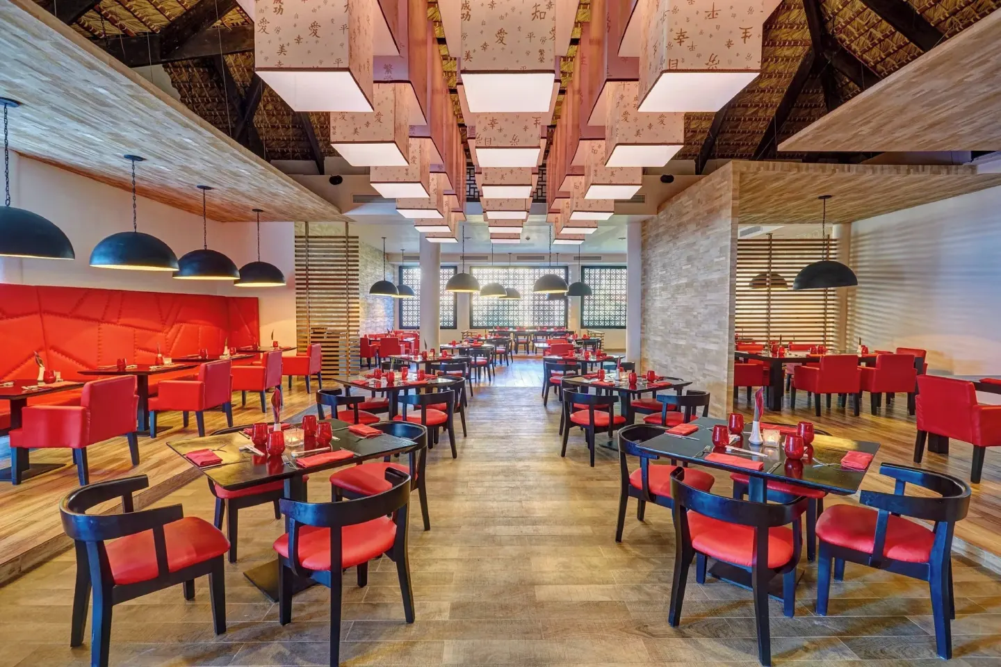 Red and black dining room with lantern lights at Royalton Hideaway Punta Cana Resort & Casino.